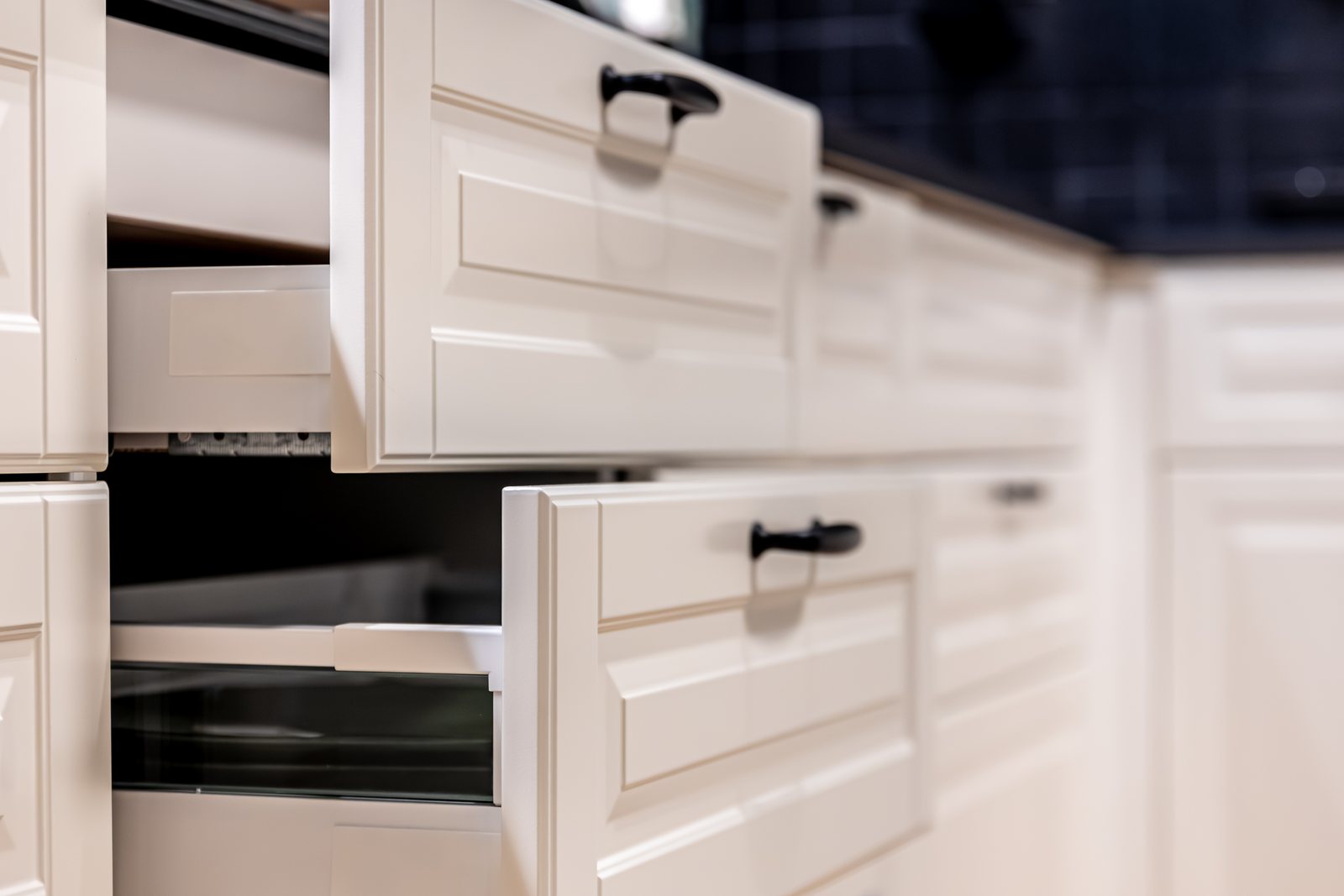 Close-up of kitchen drawers pulled open showing cabinet construction