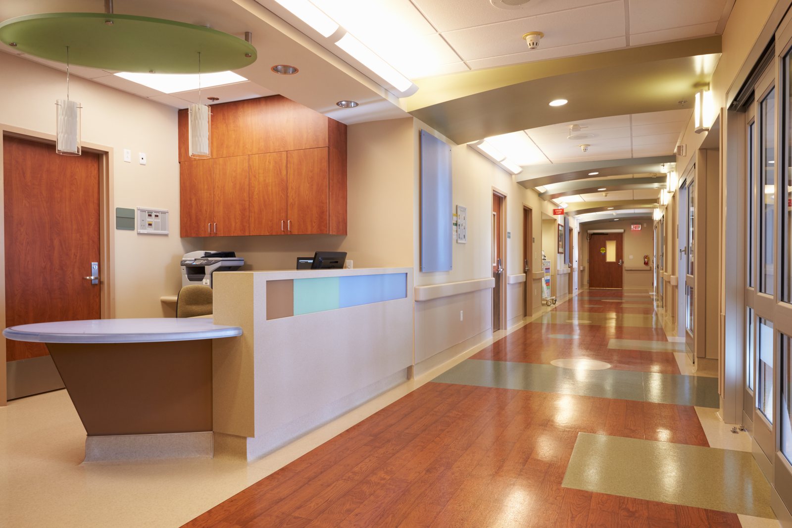 Hospital corridor and reception desk with wood-panelled millwork