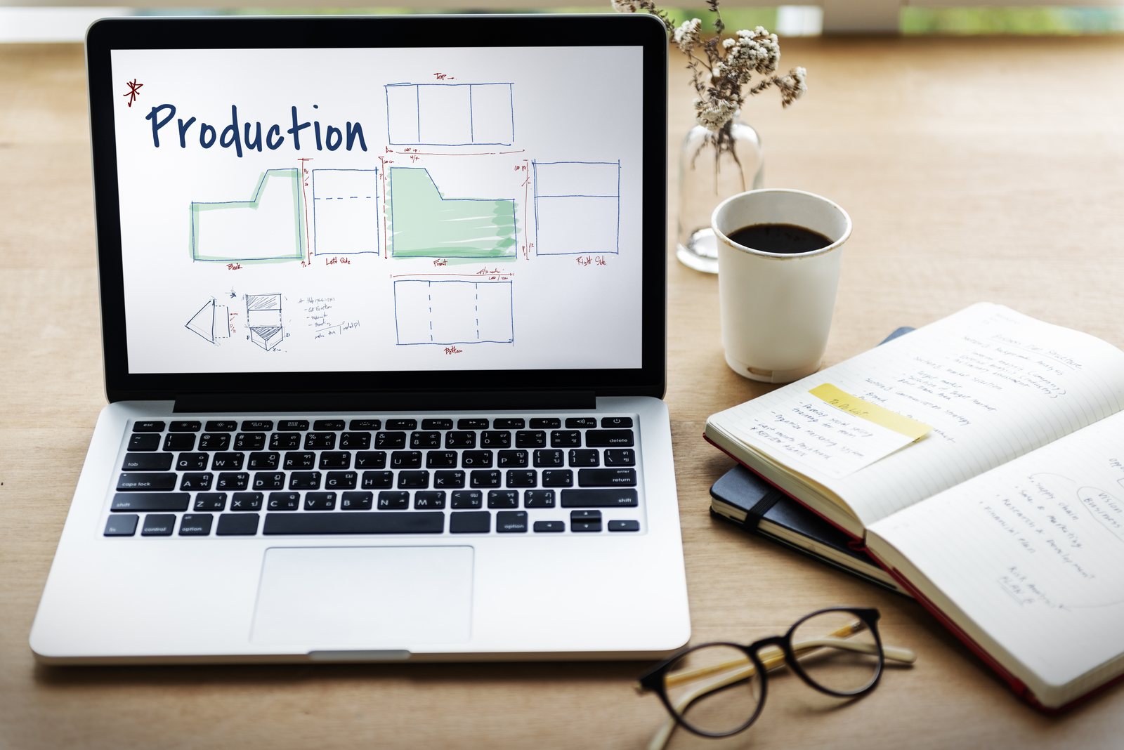 Laptop screen showing a hand-sketched orthographic production drawing with front, back, side and bottom views