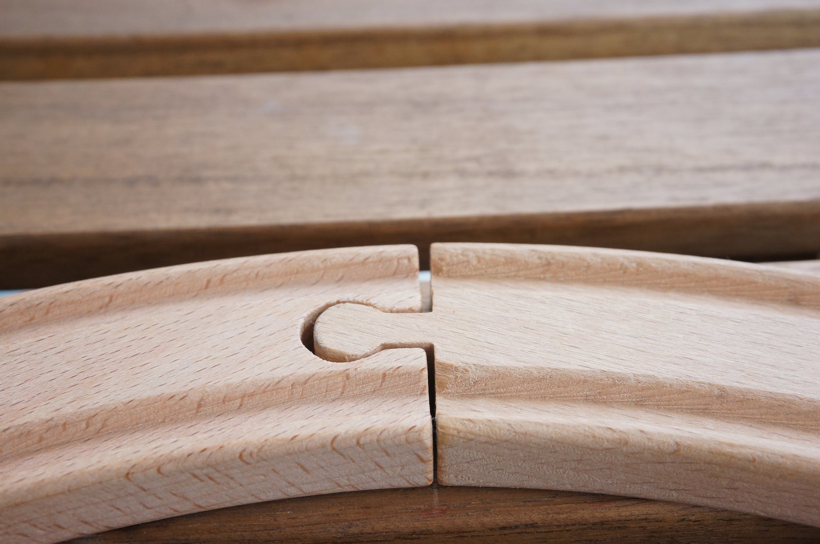 Close-up of a curved wooden joint between two interlocking pieces